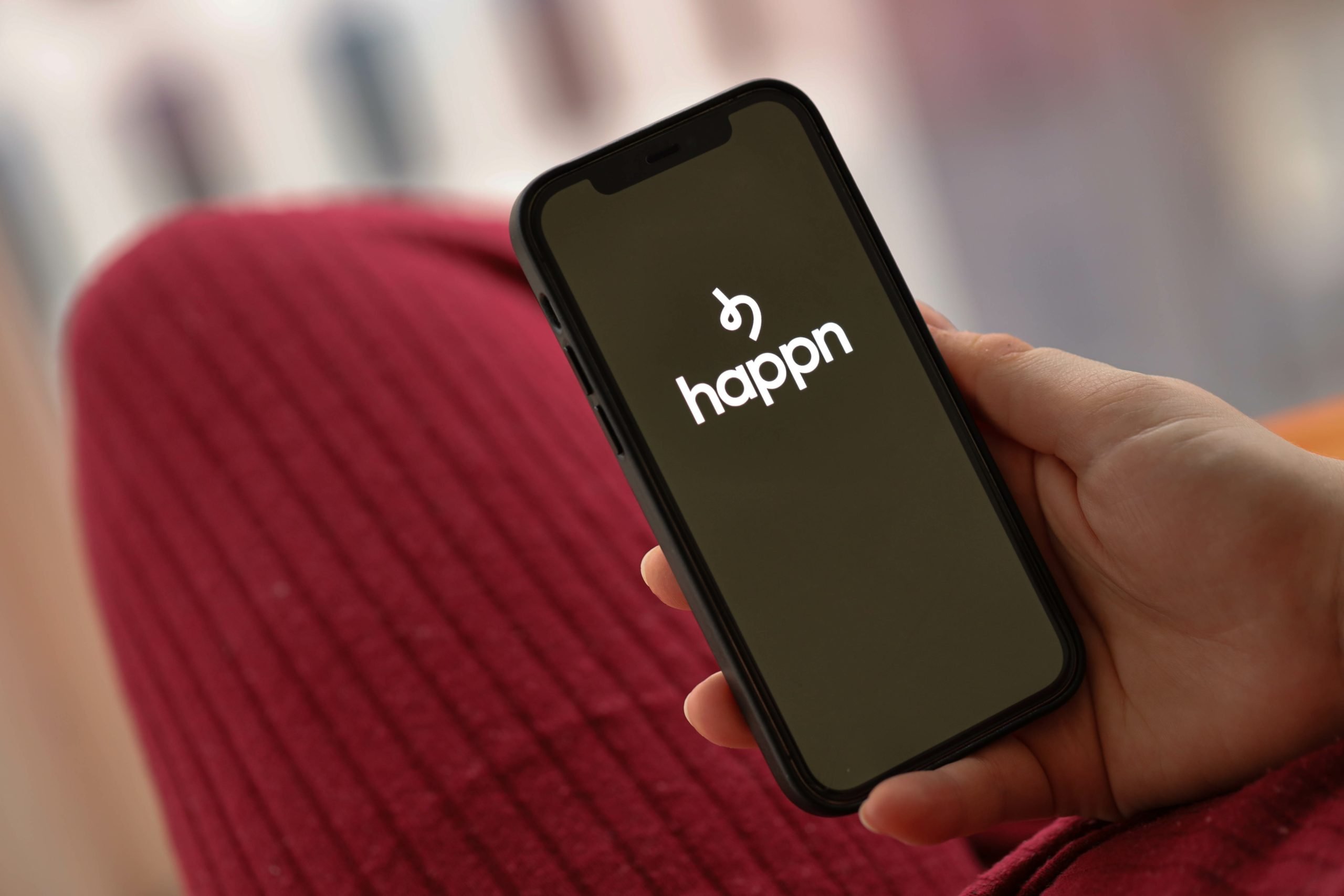 Happn logo of famous dating website or app on iPhone display screen close up